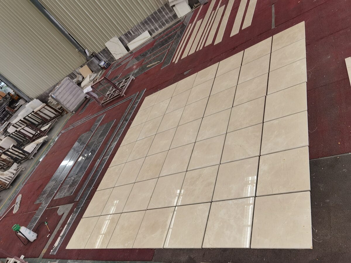Crema Marfil Marble pieces arranged for dry layout color matching and project inspection